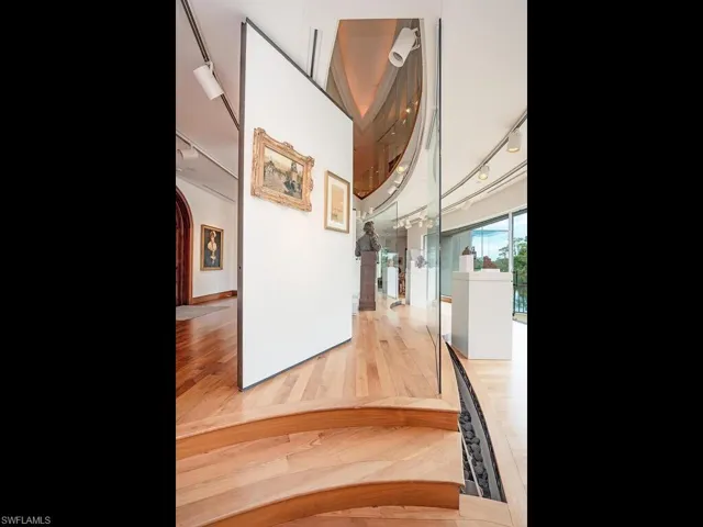 Hallway with hardwood / wood-style flooring