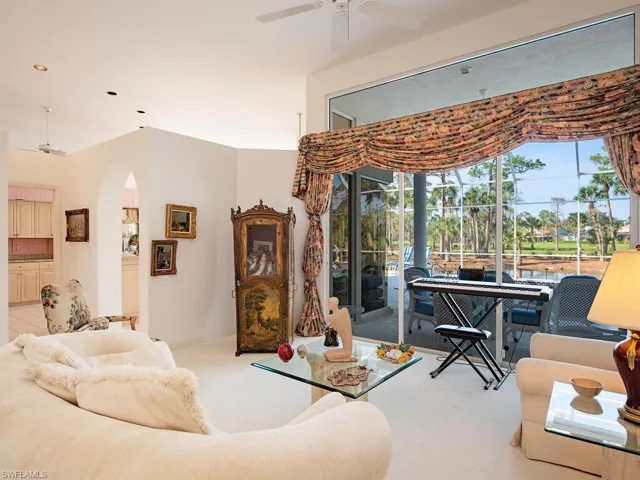 Living room featuring light carpet and ceiling fan