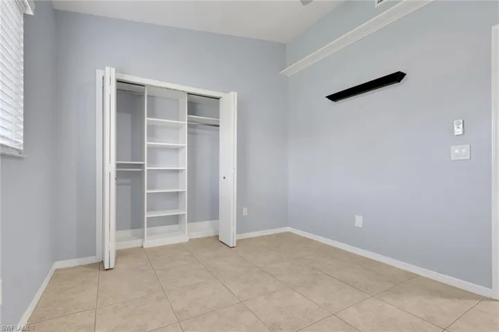 Neutral-toned tile flooring complements light blue wall paint