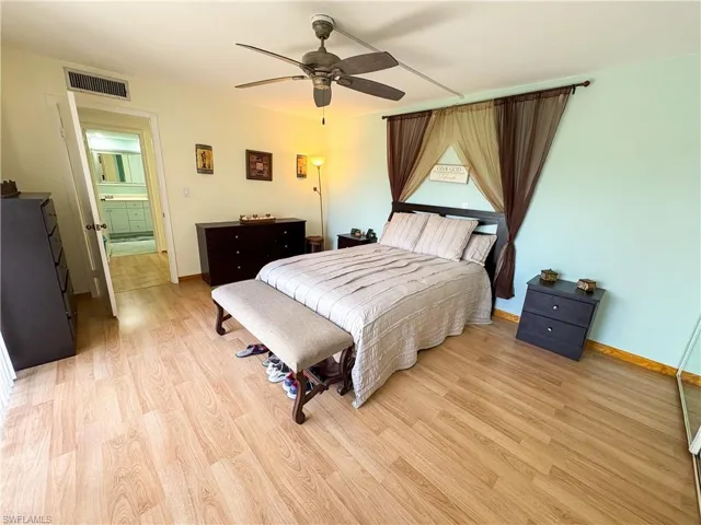 Bedroom with ceiling fan and light hardwood / wood-style flooring