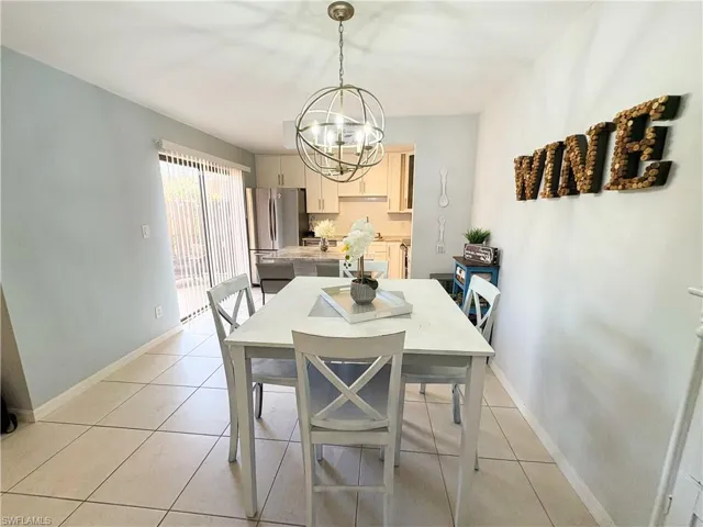 Dining room featuring an inviting chandelier and light tile patterned floors