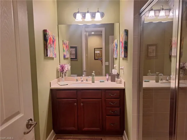 Full bath featuring vanity and a stall shower