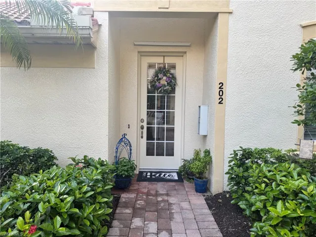 Entrance to property with stucco siding