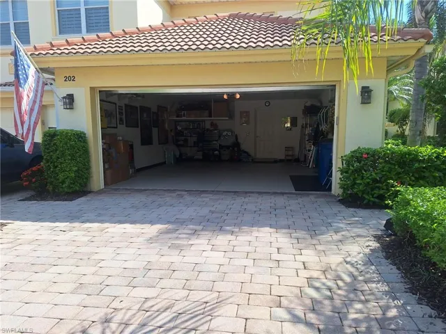 Garage featuring decorative driveway