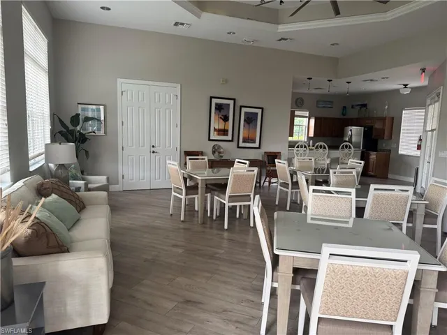 Dining space with wood finished floors and ornamental molding