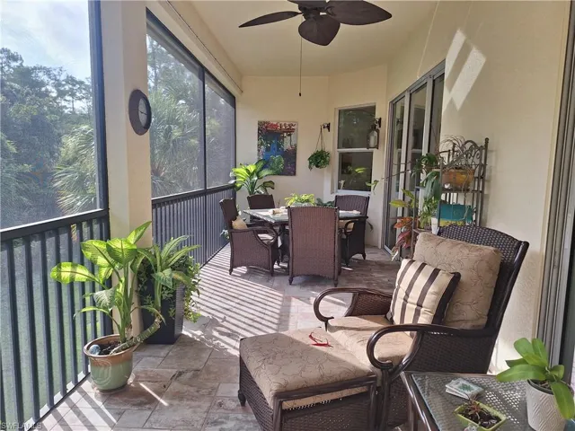 Sunroom with a ceiling fan and outdoor dining area