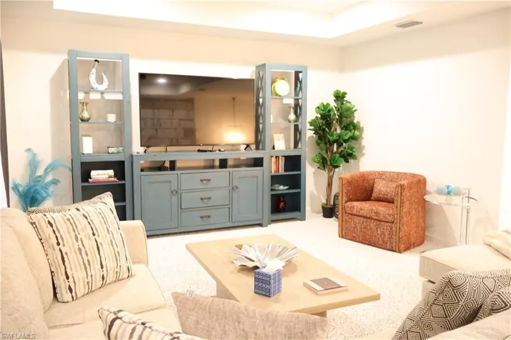 Living area featuring light carpet