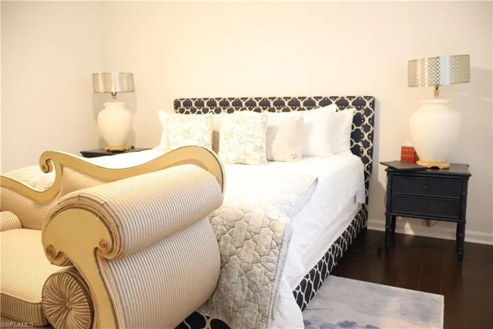 Bedroom with wood finished floors and baseboards