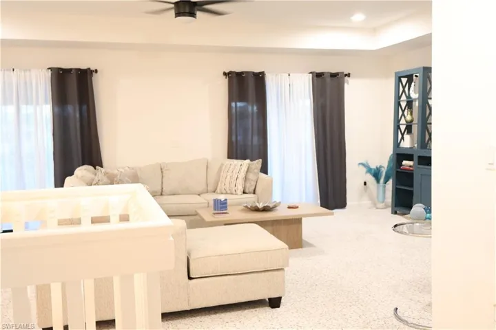 Bedroom with speckled floor and recessed lighting