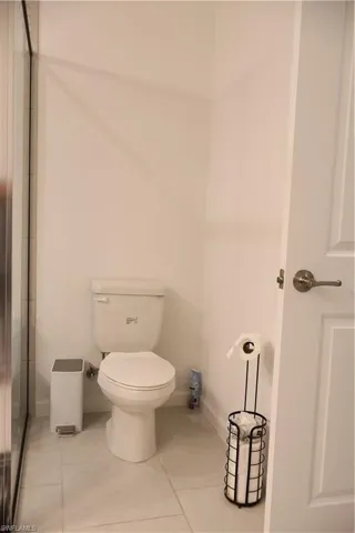 Bathroom featuring tile patterned flooring and a shower with door