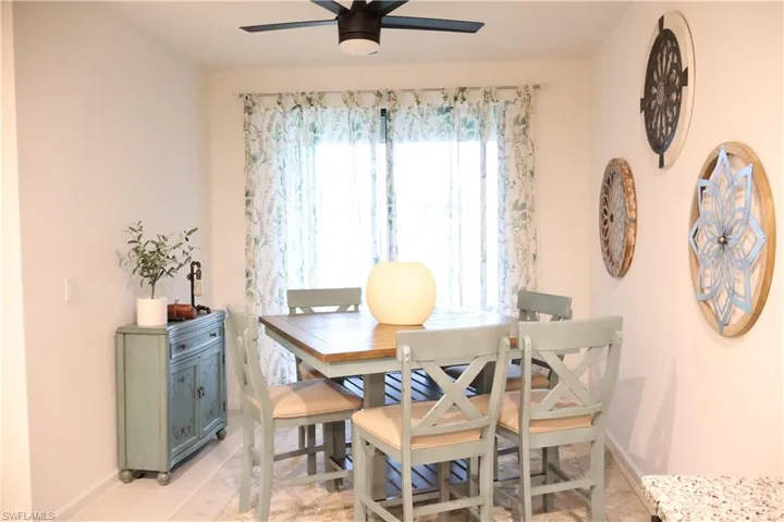 Dining area featuring ceiling fan and baseboards