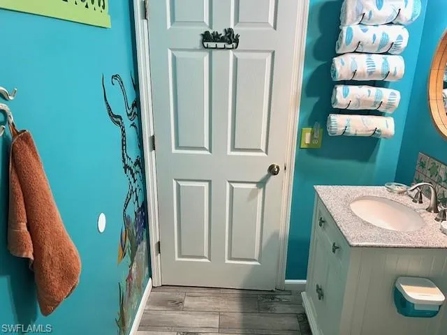 Bathroom with vanity and hardwood / wood-style flooring