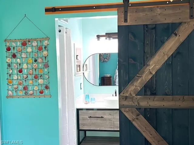 Bathroom with new vanity and tiles along with barn door