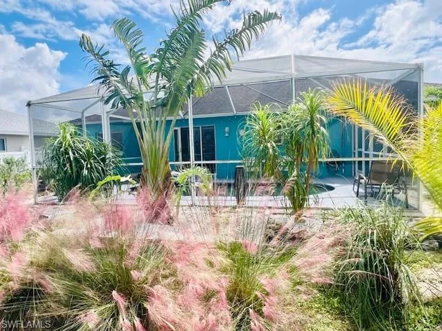 Rear view of property featuring a patio and a lanai