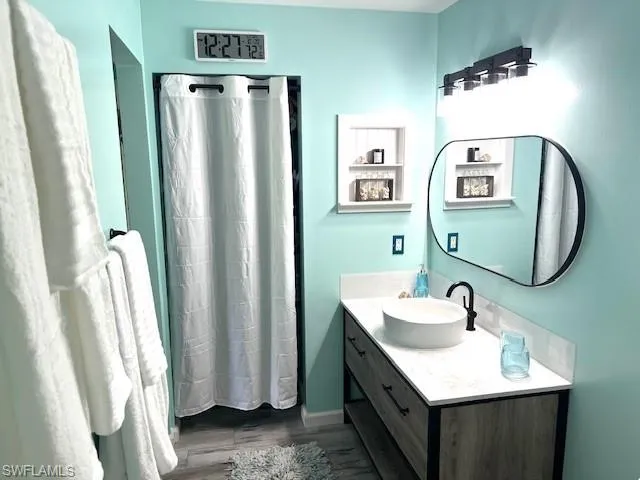 Bathroom featuring vanity and wood-type flooring