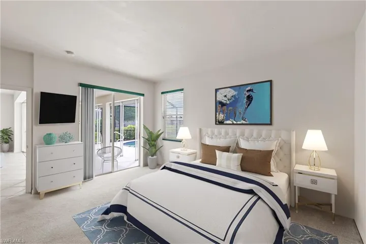 Carpeted bedroom featuring access to outside screened lanai