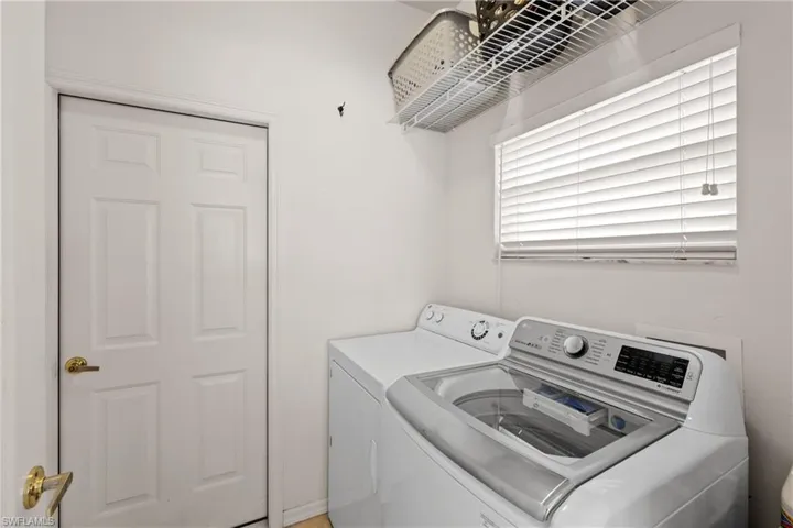 View of tiled laundry room with washer and dryer.