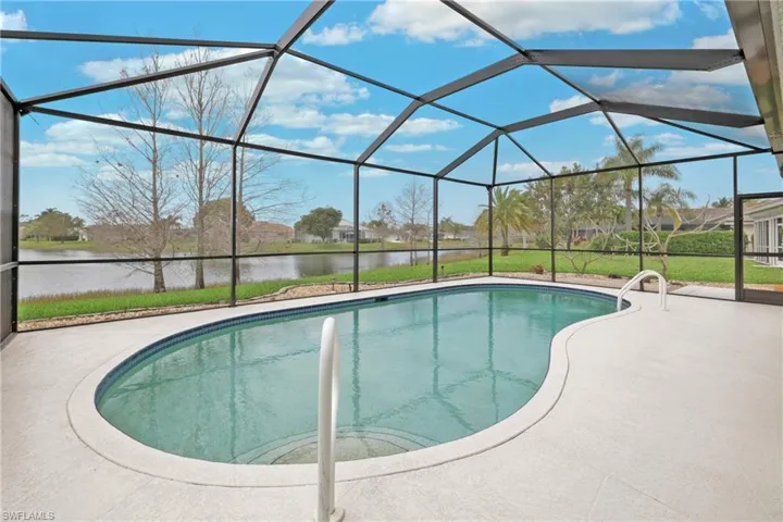 View of swimming pool with a patio, a lake water view, and a screened lanai