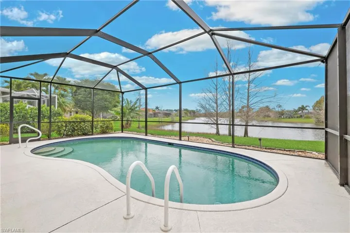 View of pool with a lake water view, a patio area, and a screened lanai