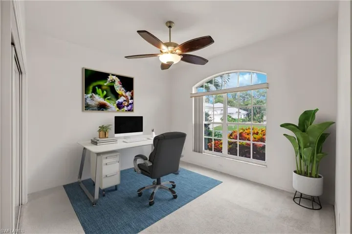 Spare Bedroom with light carpet and ceiling fan