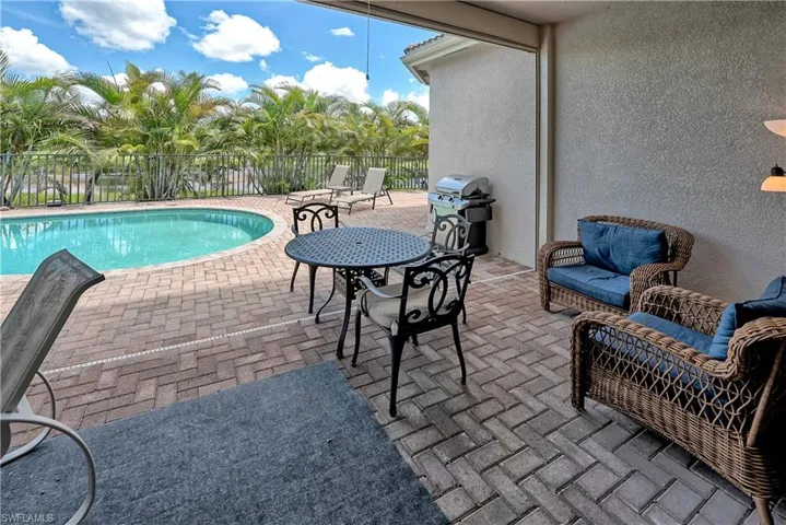 View of swimming pool featuring a patio and grilling area