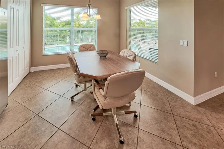 Dining area featuring plenty of natural light, a notable chandelier, and light tile patterned floors