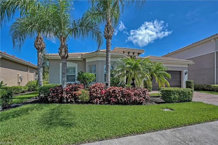 Mediterranean / spanish home with a garage and a front yard