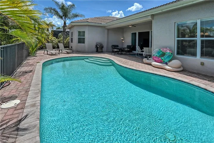 View of pool with a patio and ceiling fan