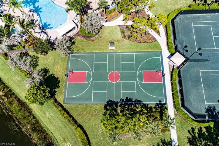 View of sport court featuring a lawn