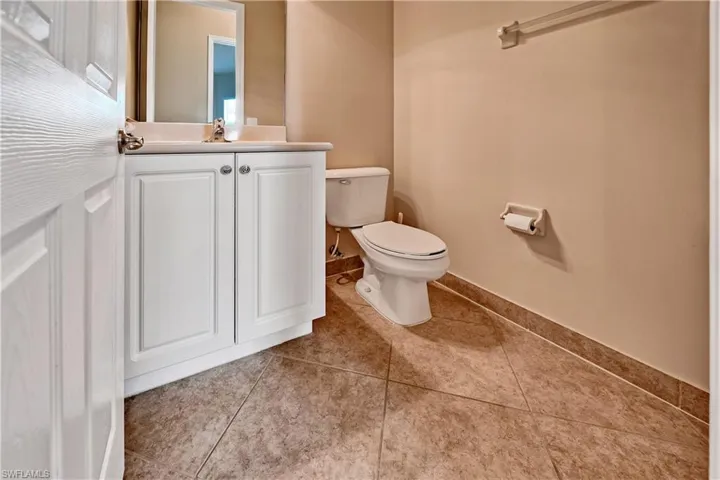 Bathroom featuring vanity, toilet, and tile patterned flooring