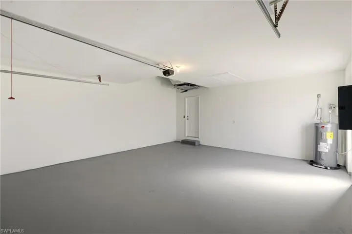 Garage with water heater and electric panel
