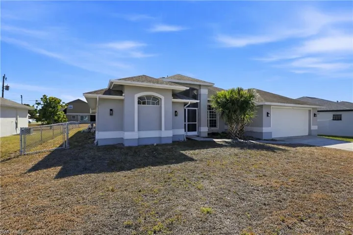 View of front of home featuring stucco siding, a garage, and concrete driveway