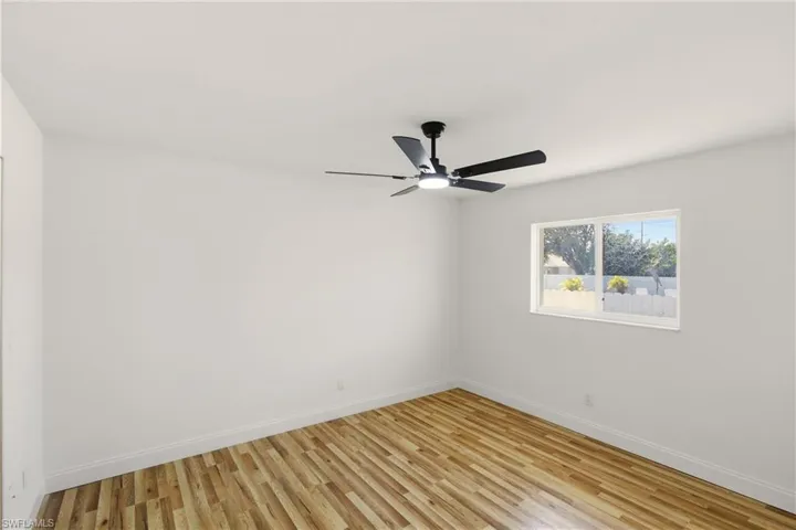 Empty room featuring light wood-style flooring and a ceiling fan