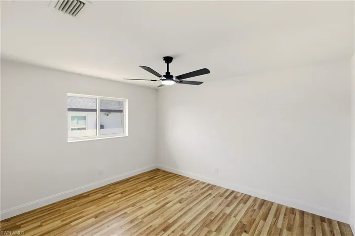 Spare room with light wood-style floors and a ceiling fan