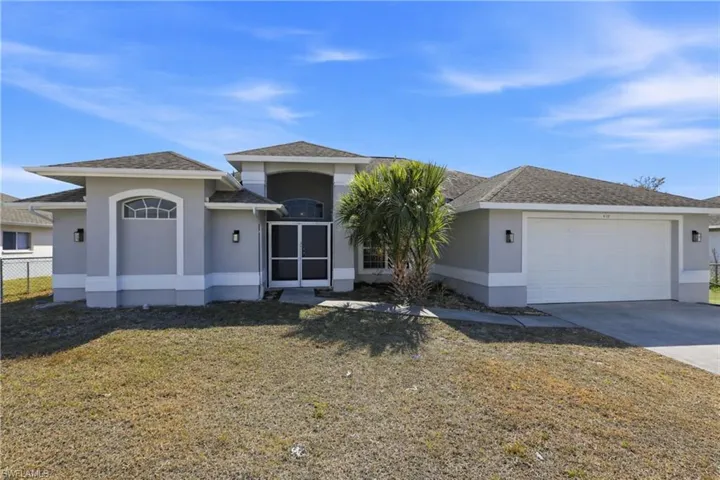 View of front facade with a garage, stucco siding, a front yard, driveway, and a shingled roof