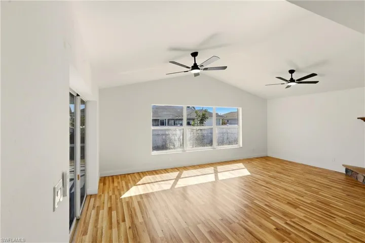Unfurnished living room featuring light wood-type flooring and ceiling fan