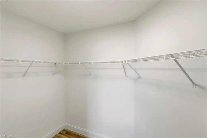 Walk in closet featuring wood finished floors