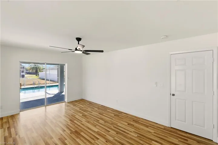 Spare room with a ceiling fan and light wood-style flooring