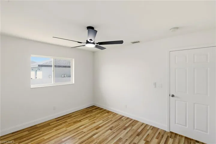 Spare room featuring light wood-type flooring and ceiling fan