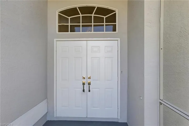 Entrance to property with stucco siding
