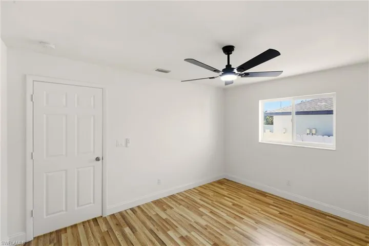 Empty room featuring light wood-style flooring and ceiling fan