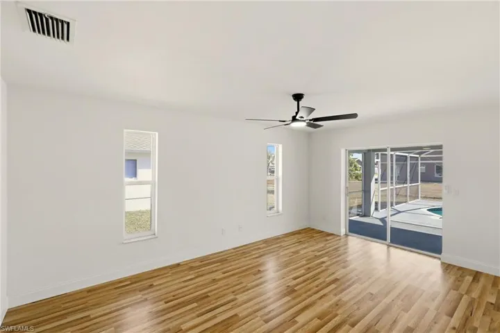 Empty room with light wood-style floors and a ceiling fan