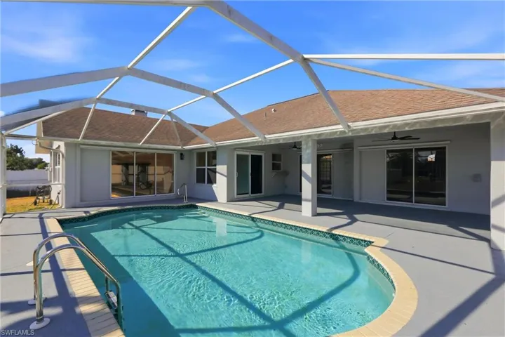 Outdoor pool featuring a lanai, a patio area, and a sunroom