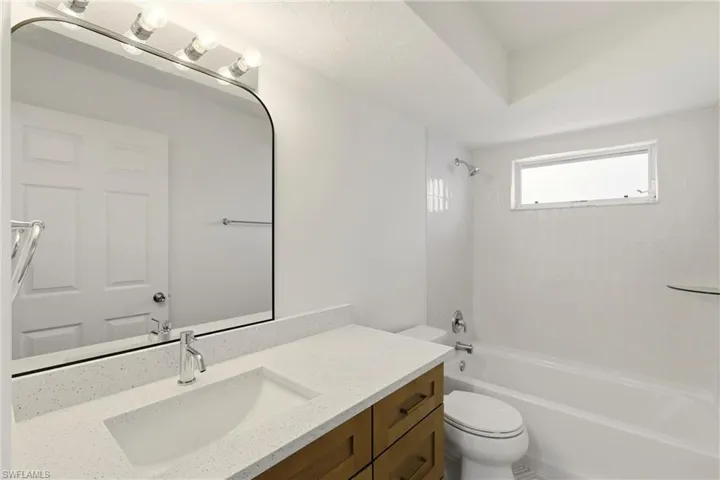 Bathroom featuring vanity and shower / bath combination