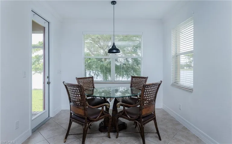 Eat-in Kitchen tiled flooring with access to rear lanai and yard with a wealth of natural light