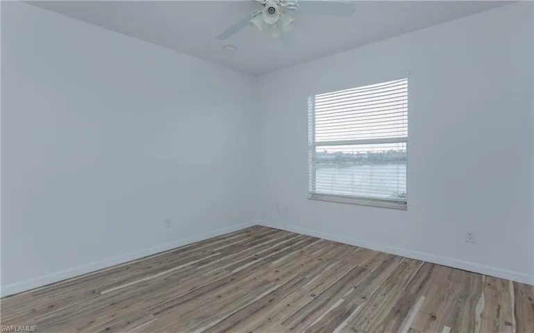Bedroom #3 upstairs with light LVP flooring  and ceiling fan