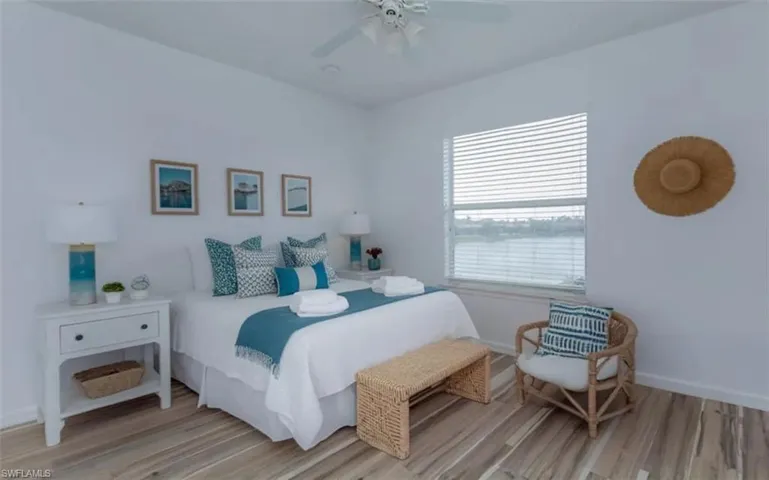 STAGED BEDROOM #2 WITH LIGHT LVP FLOORING AND CEILING FAN
