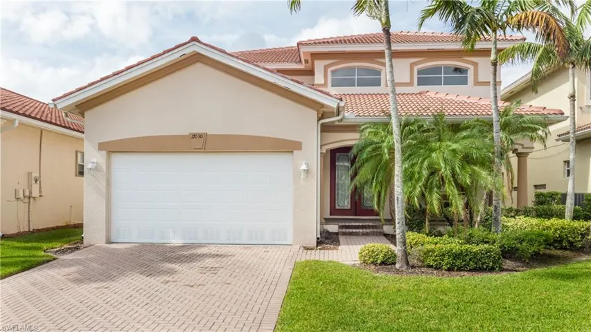 Mediterranean / spanish-style house with a front lawn and a garage
