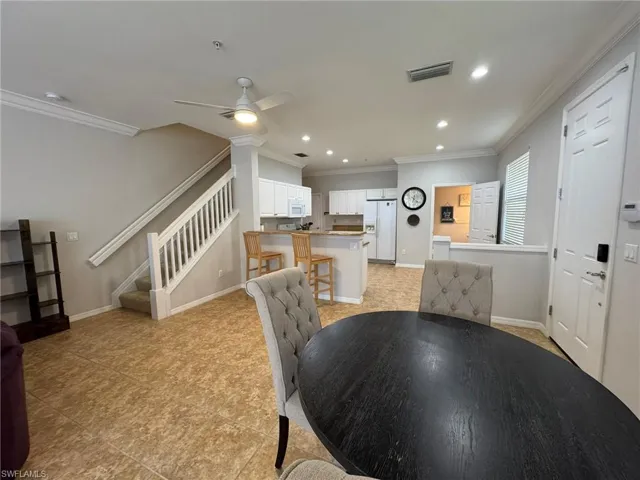 Dining space featuring ceiling fan and ornamental molding