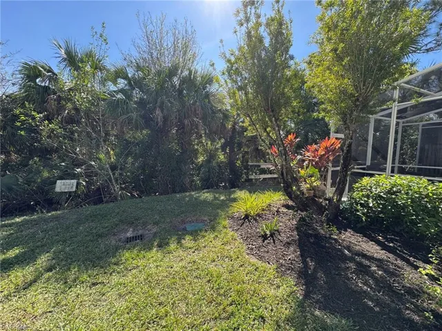 View of yard with glass enclosure